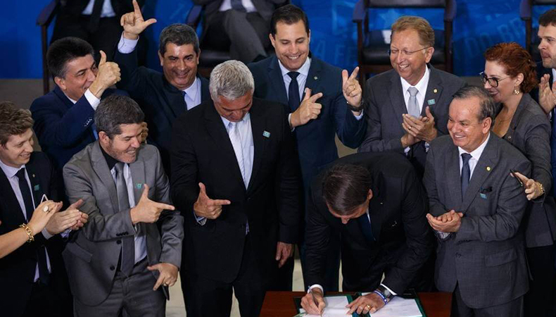 Bolsonaro assinando decreto de flexibilização do porte de armas / Foto: Daniel Marenco